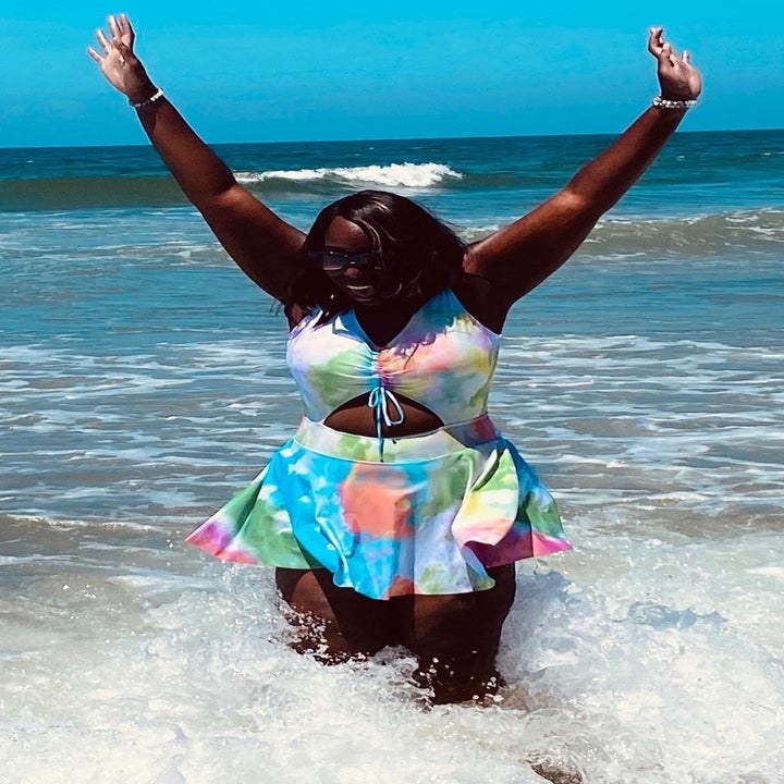 reviewer wearing the tie dye designed bathing suit