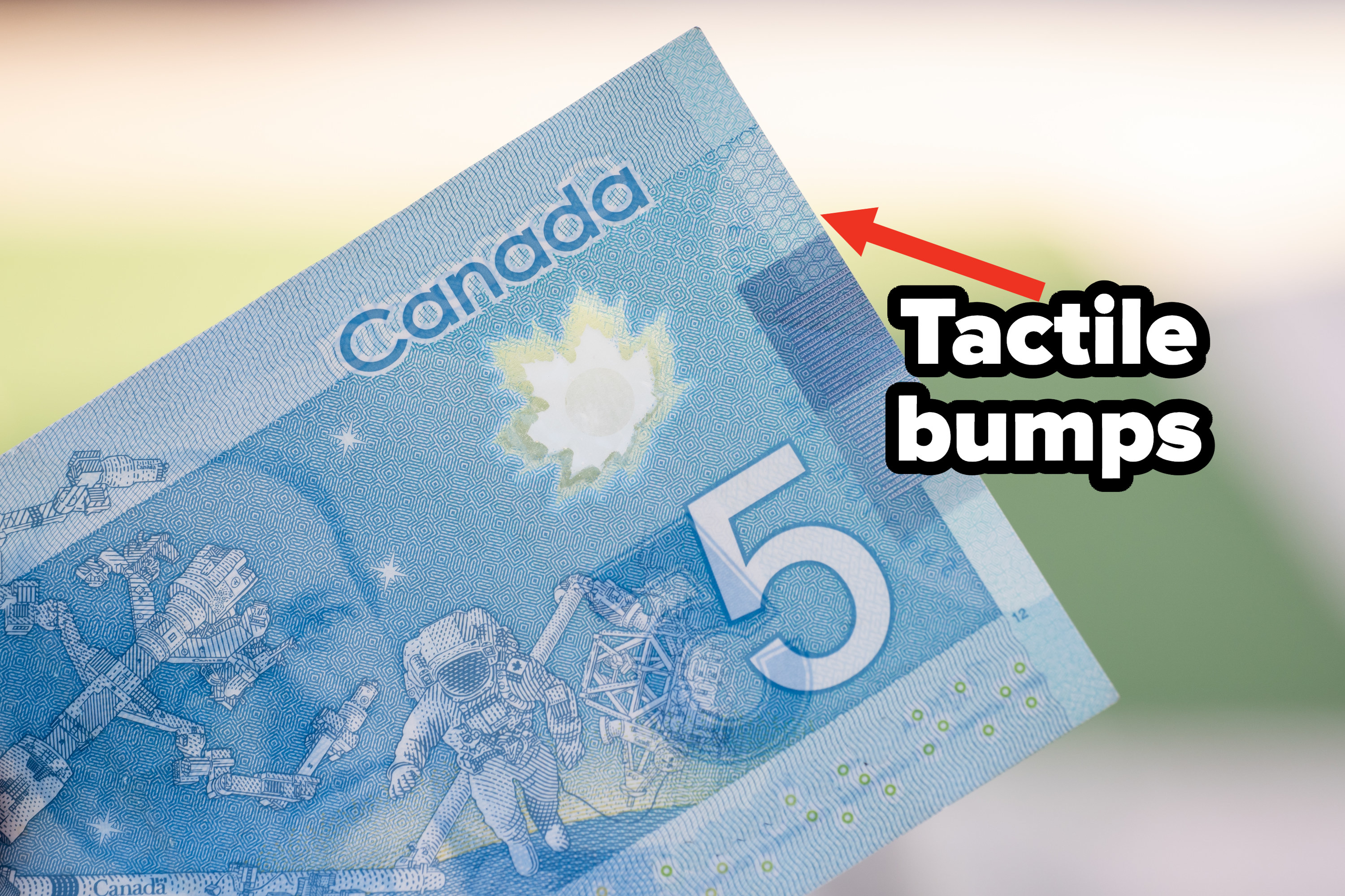 Canadian 5 dollar bill with tactile bumps in the top righthand corner