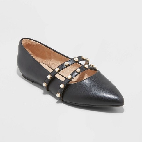 A black pointed toe shoe with dual bedazzled straps
