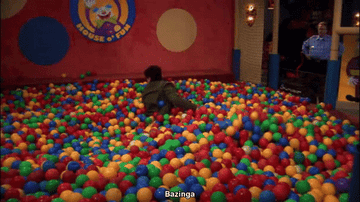 Sheldon from &quot;The Big Bang Theory&quot; popping up from a ball pit yelling &quot;Bazinga!&quot; while Leonard looks for him