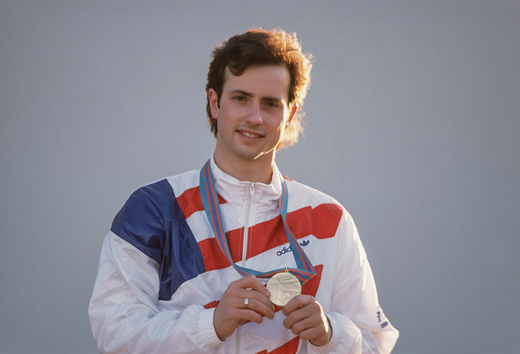 Brian poses for a photo while holding his gold medal