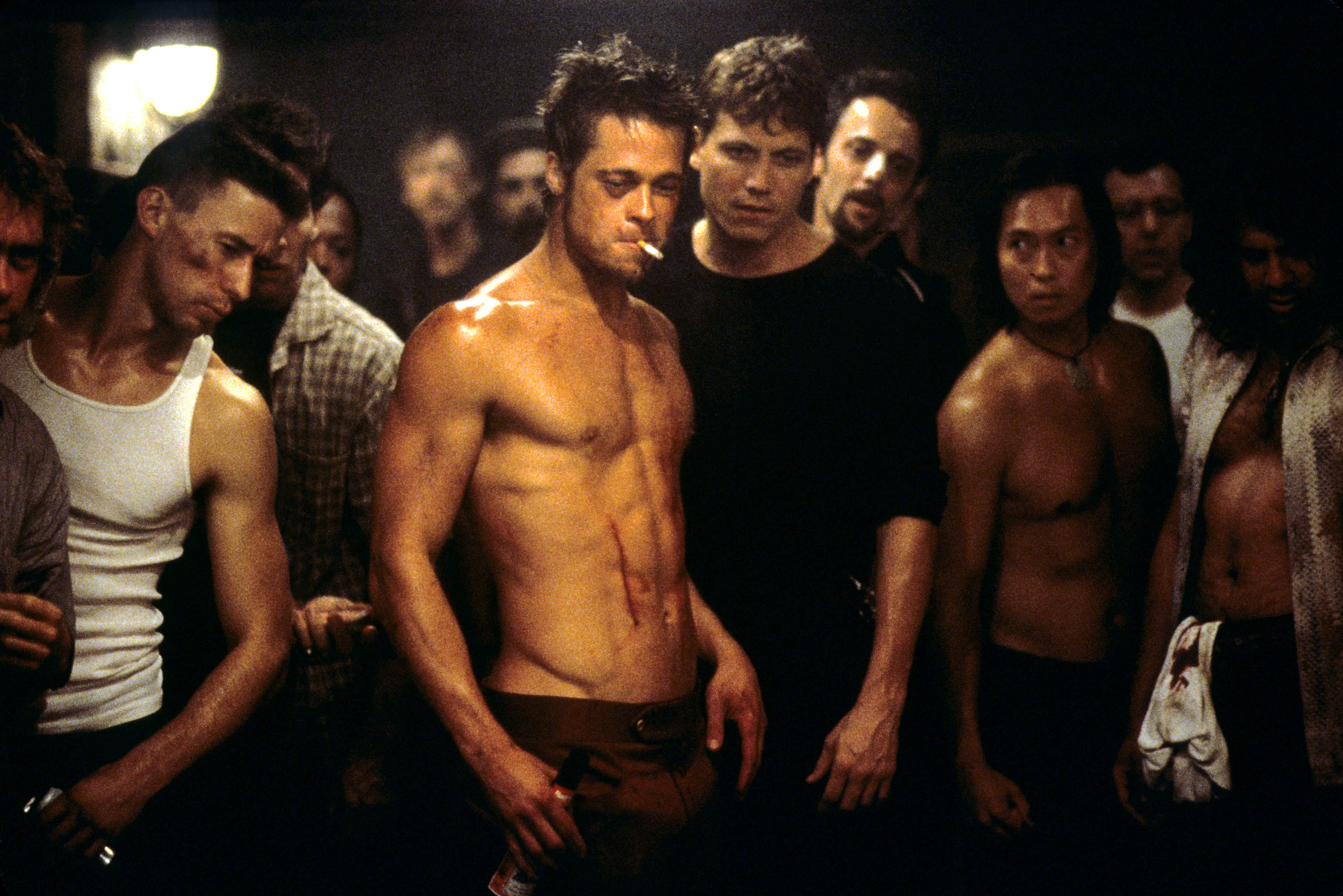A beaten-up Brad Pitt among a crowd in &quot;Fight Club&quot;