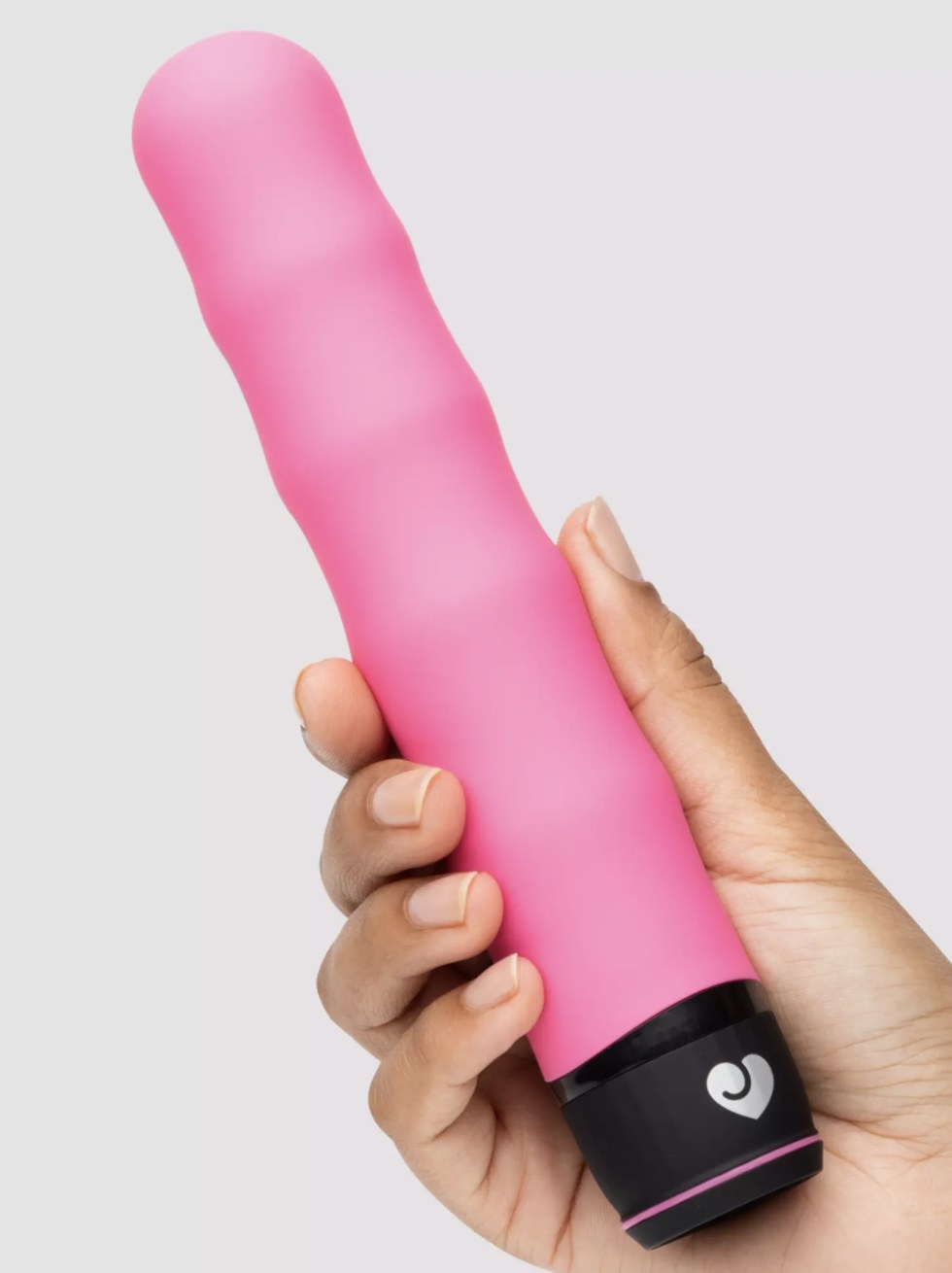 The pink vibrator held in someone&#x27;s hand