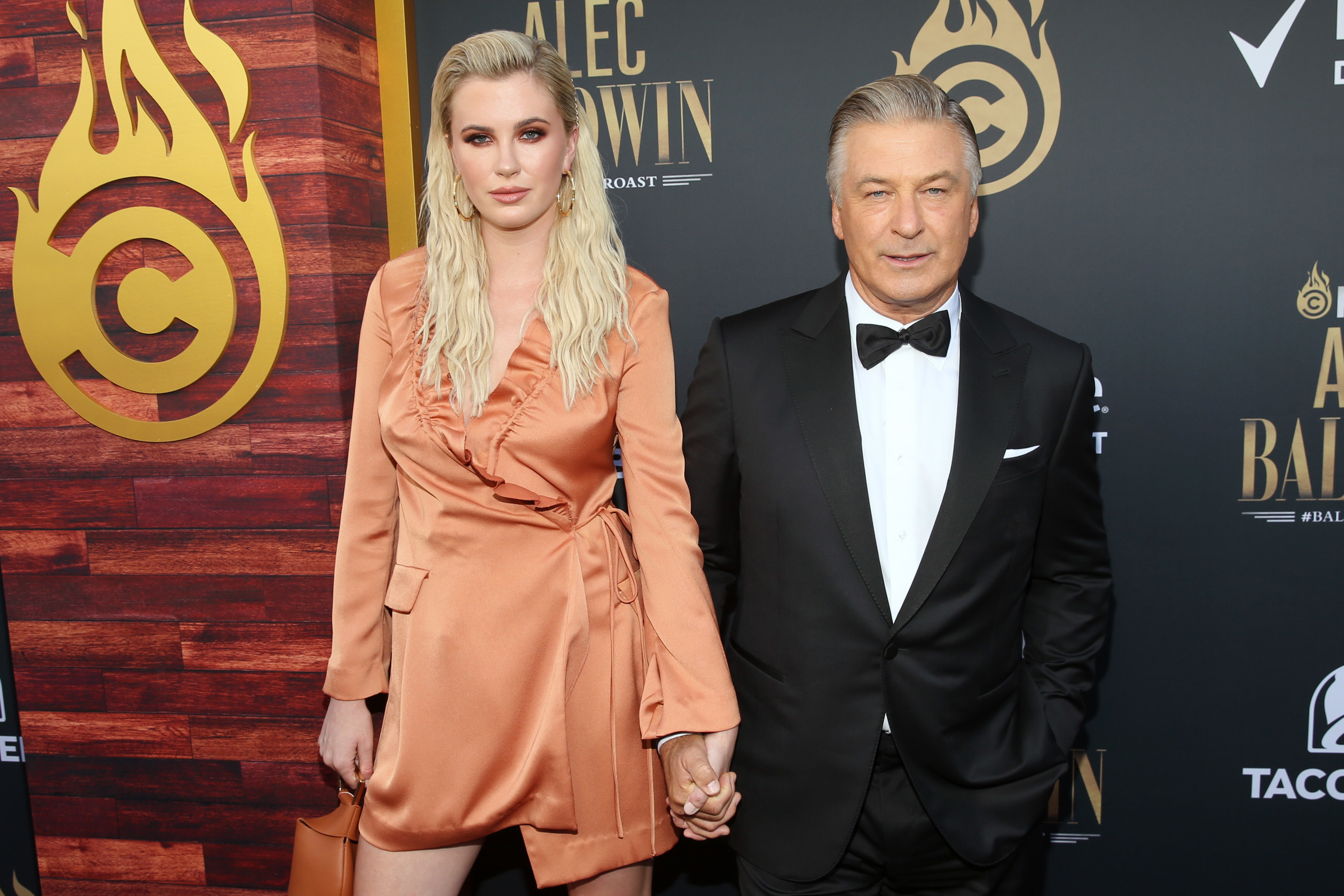 An adult Ireland holding her dad&#x27;s hand as they pose on the red carpet