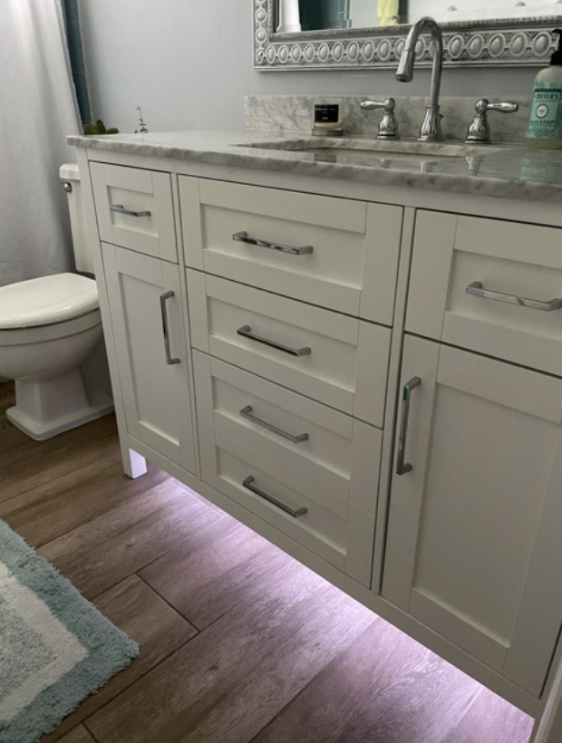 reviewer's bathroom with lights under the sink cabinets