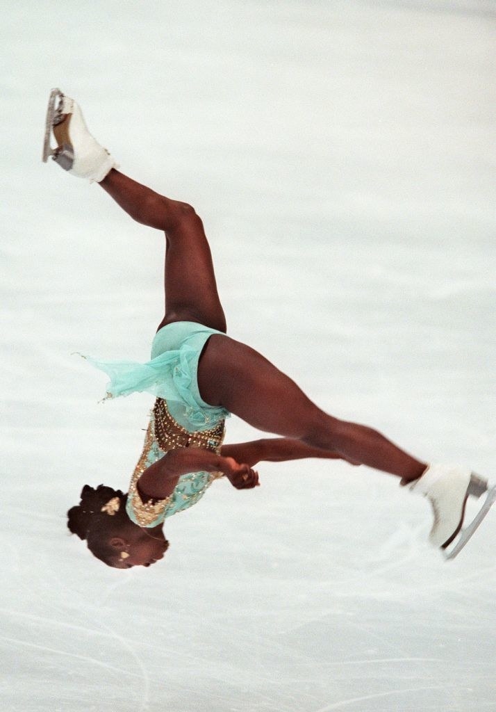 An ice skater doing a back flip