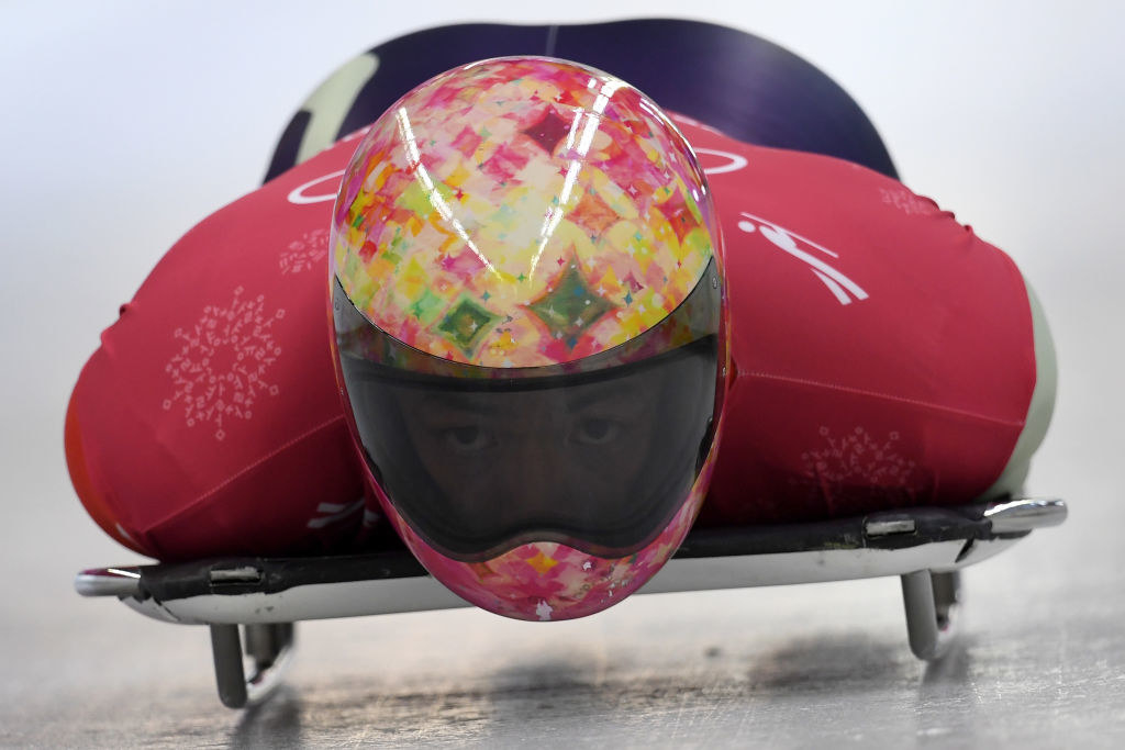 A closeup if the multi-colored helmet with diamond shapes throughout