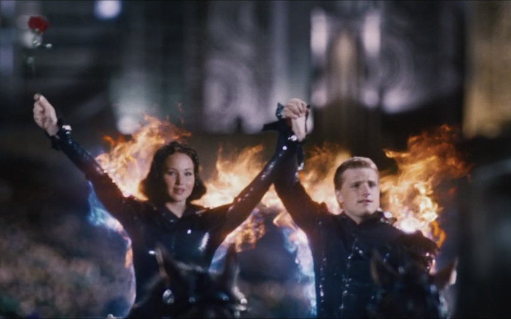 Katniss and Peeta on fire, holding hands