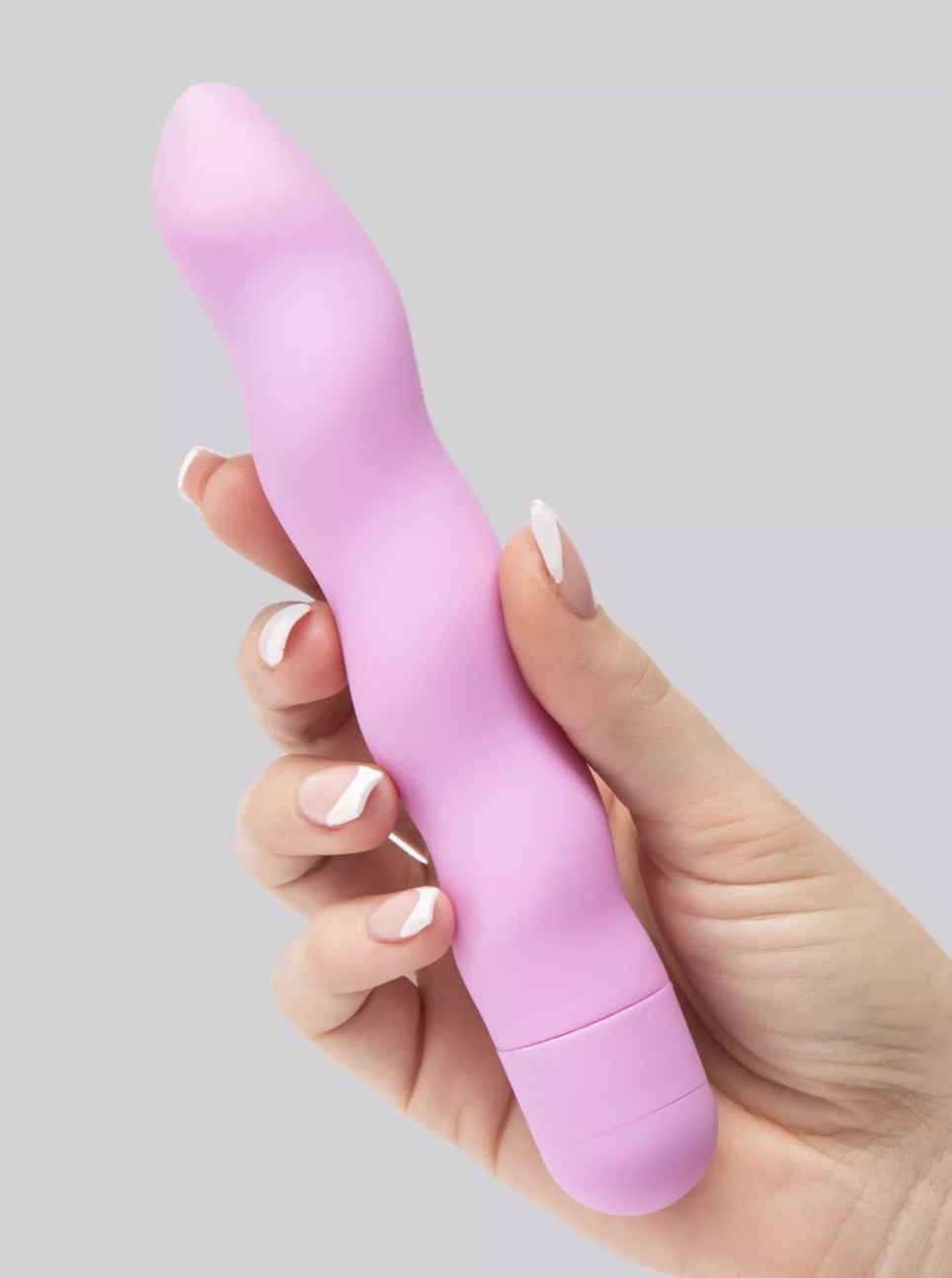 The pink wavy vibrator held in someone&#x27;s hand