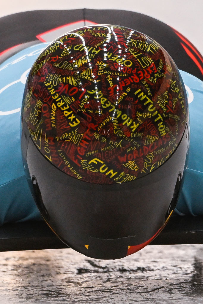 Kim&#x27;s helmet is a collage of words like joy, fun, open mind, and love