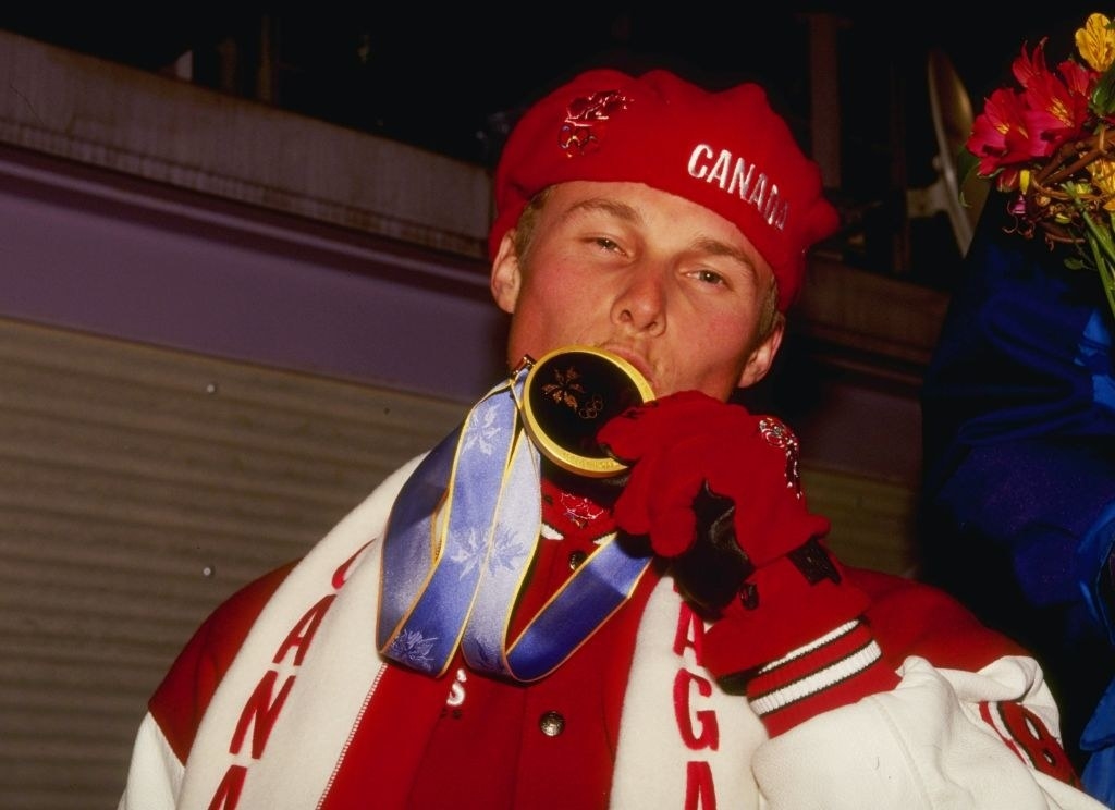 A man kissing a gold medal