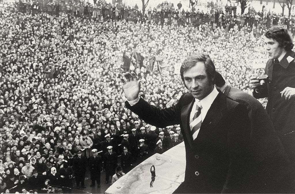 A man waving to a crowd