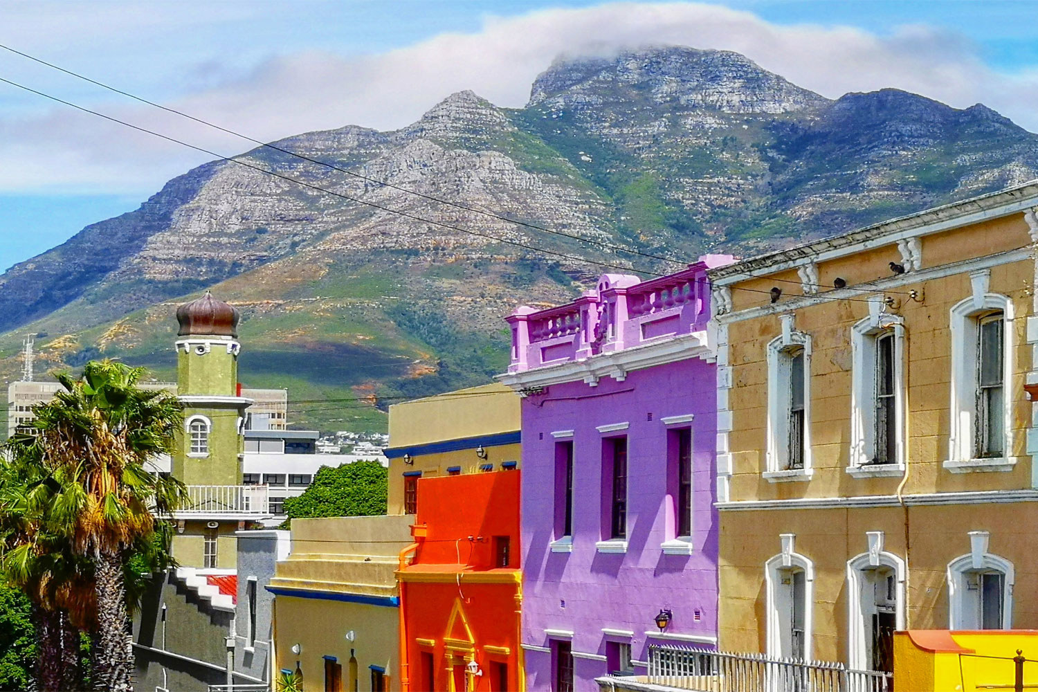 Colorful houses in front of a mountain