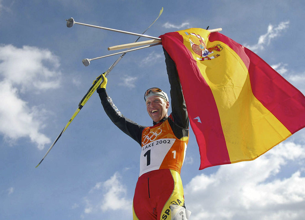 A skier holding the Spanish flag
