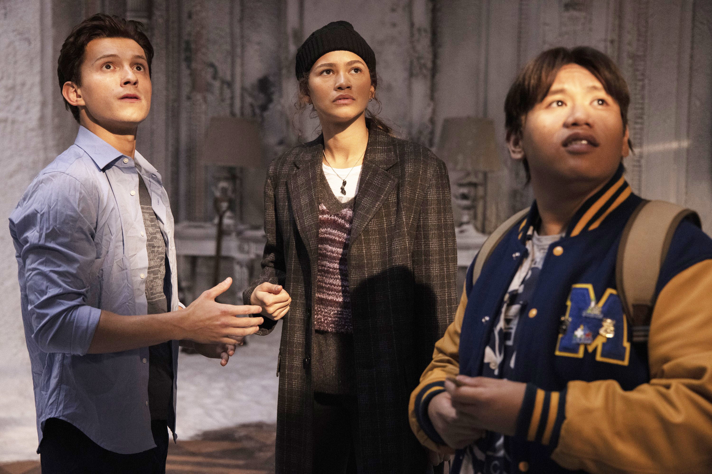 Peter, MJ, and Ned standing in a room filled with snow as they look off-screen