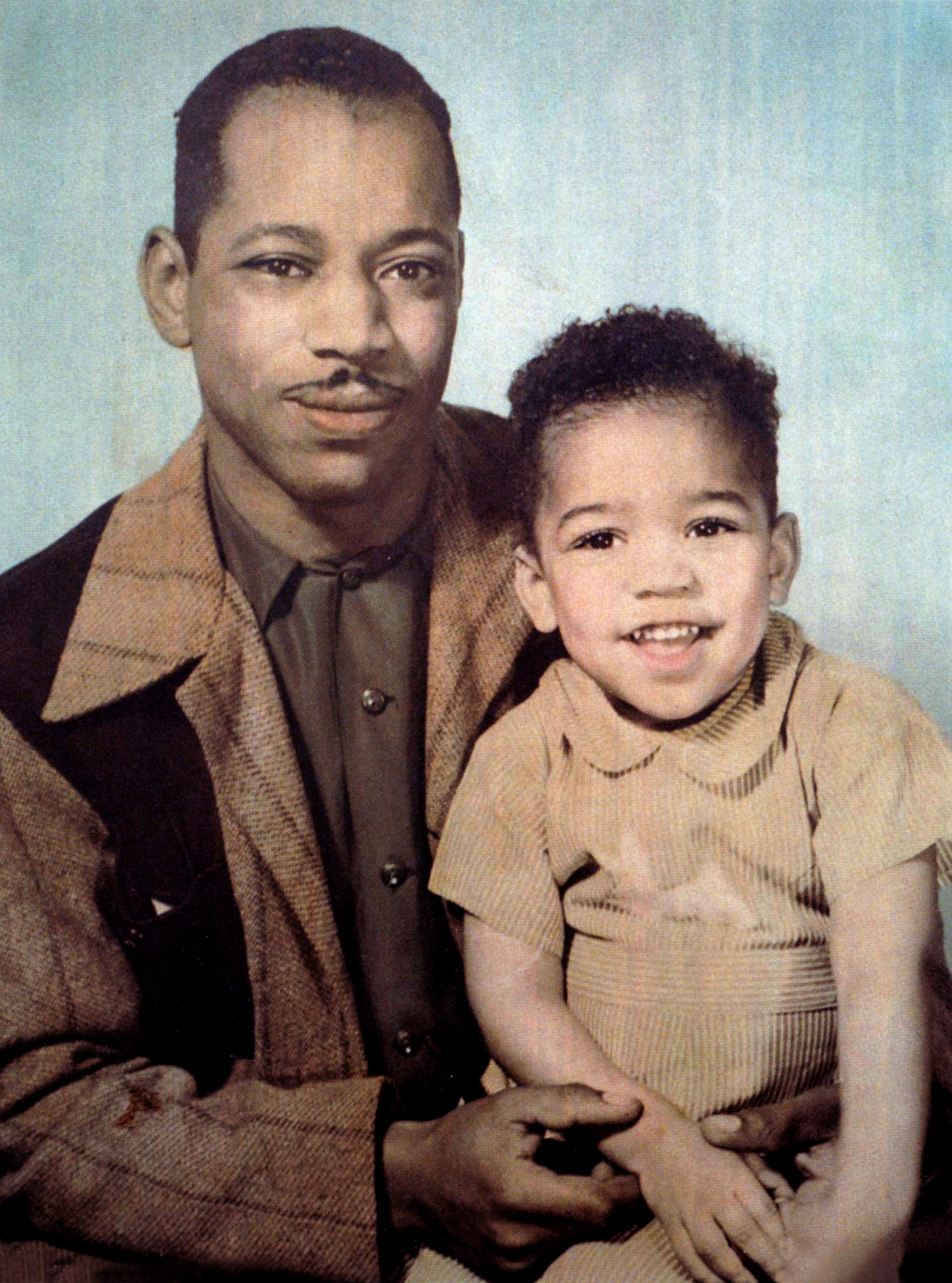 Jimi Hendrix sitting on his father&#x27;s lap for a portrait