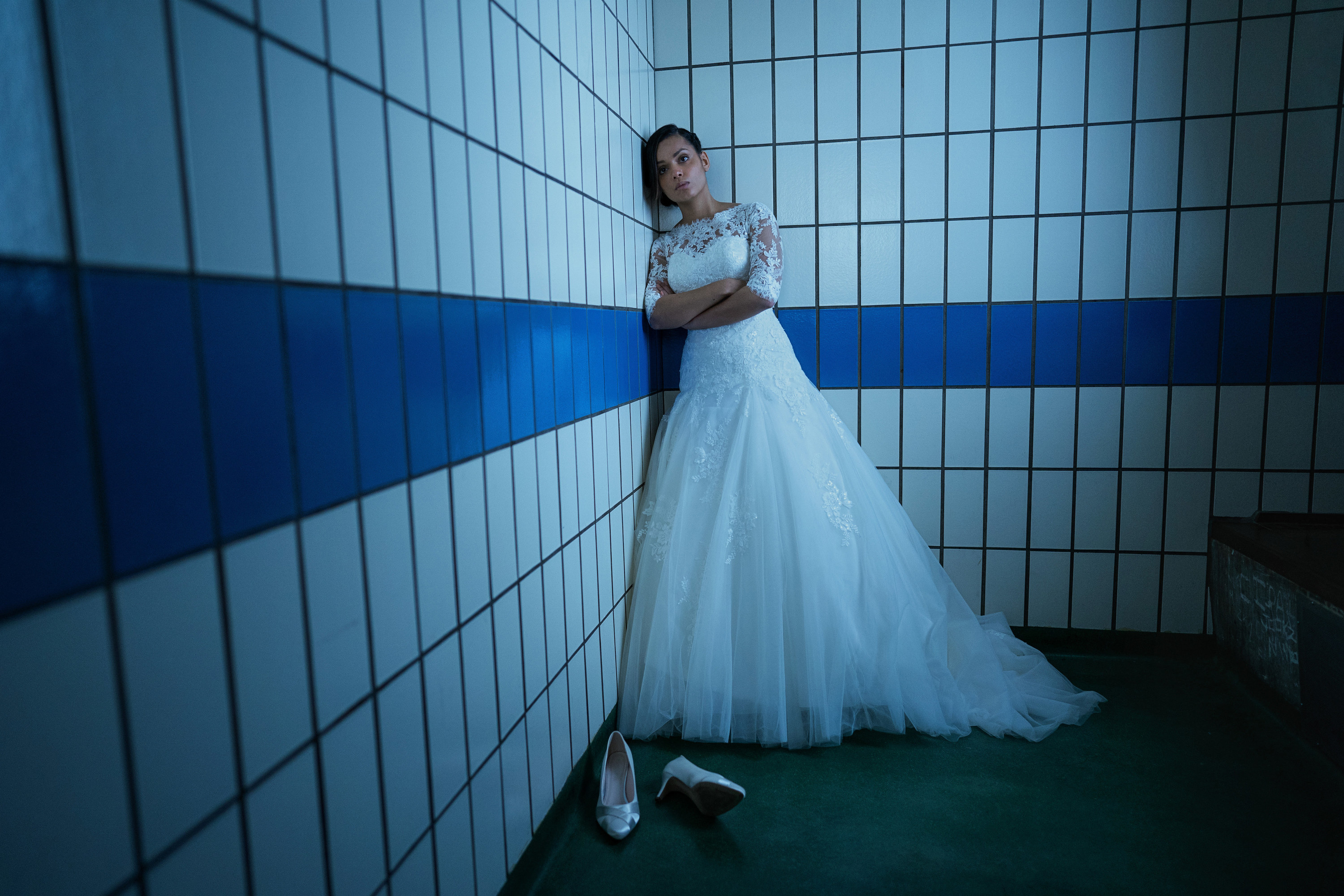 Georgina Campbell stands in a jail cell in her wedding dress
