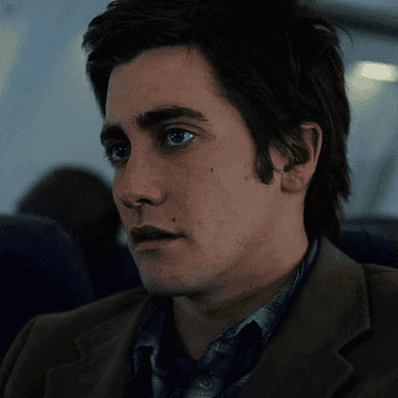 Jake Gyllenhaal looking nervous on an airplane in The Day After Tomorrow