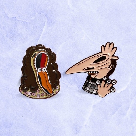 Two enamel pins of Adam and Barbara from &quot;Beetlejuice&quot;