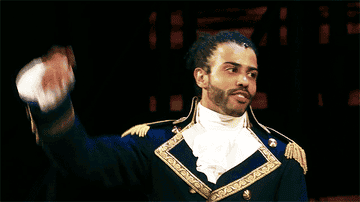 Daveed Diggs on stage in historic costume during Hamilton