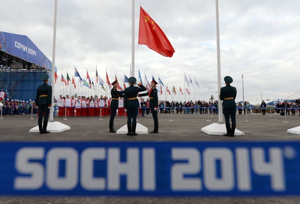 Soldiers saluting a flag