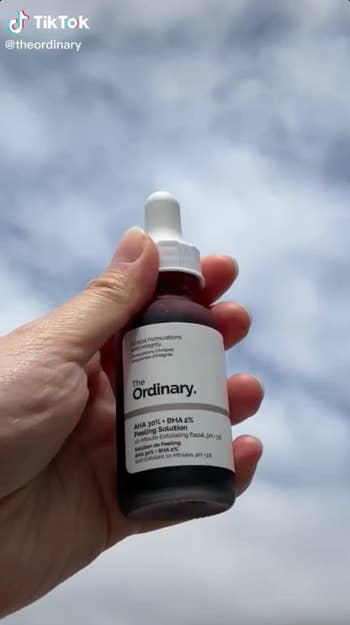 a screenshot of a person holding up the bottle from The Ordinary's TikTok
