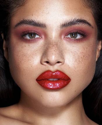 model wearing red lip pigment and red eye pigment