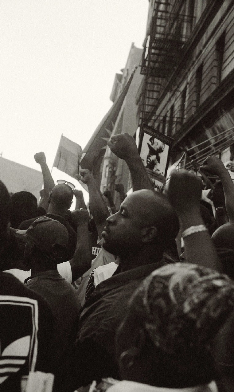 men raising their fists and looking away from the camera at a youth march 