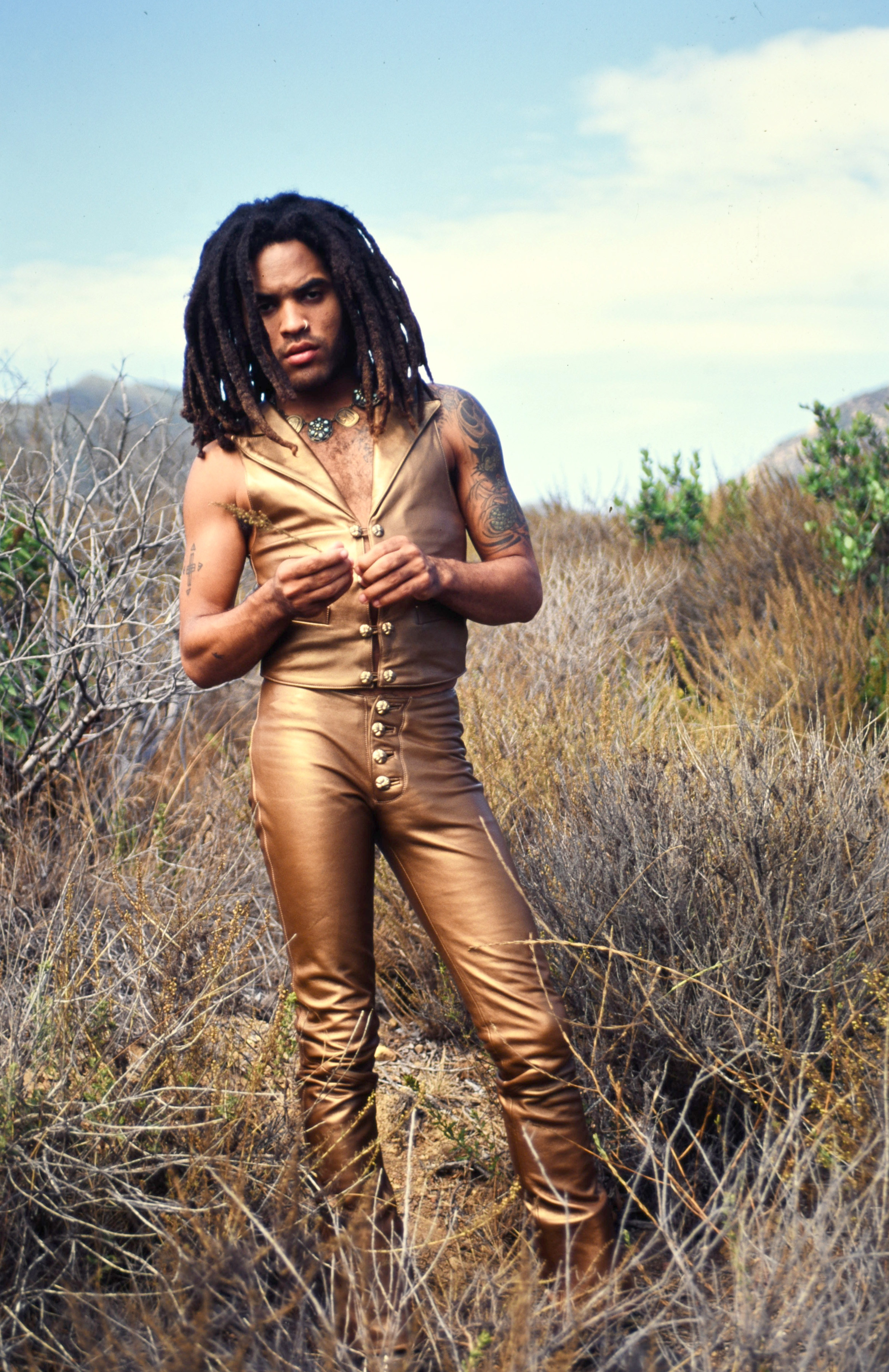 Kravitz in a leather suit in a field in at his home