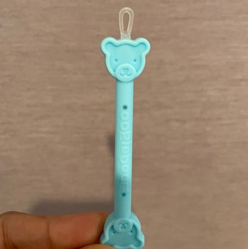 A closeup of the bear booger cleaner tool