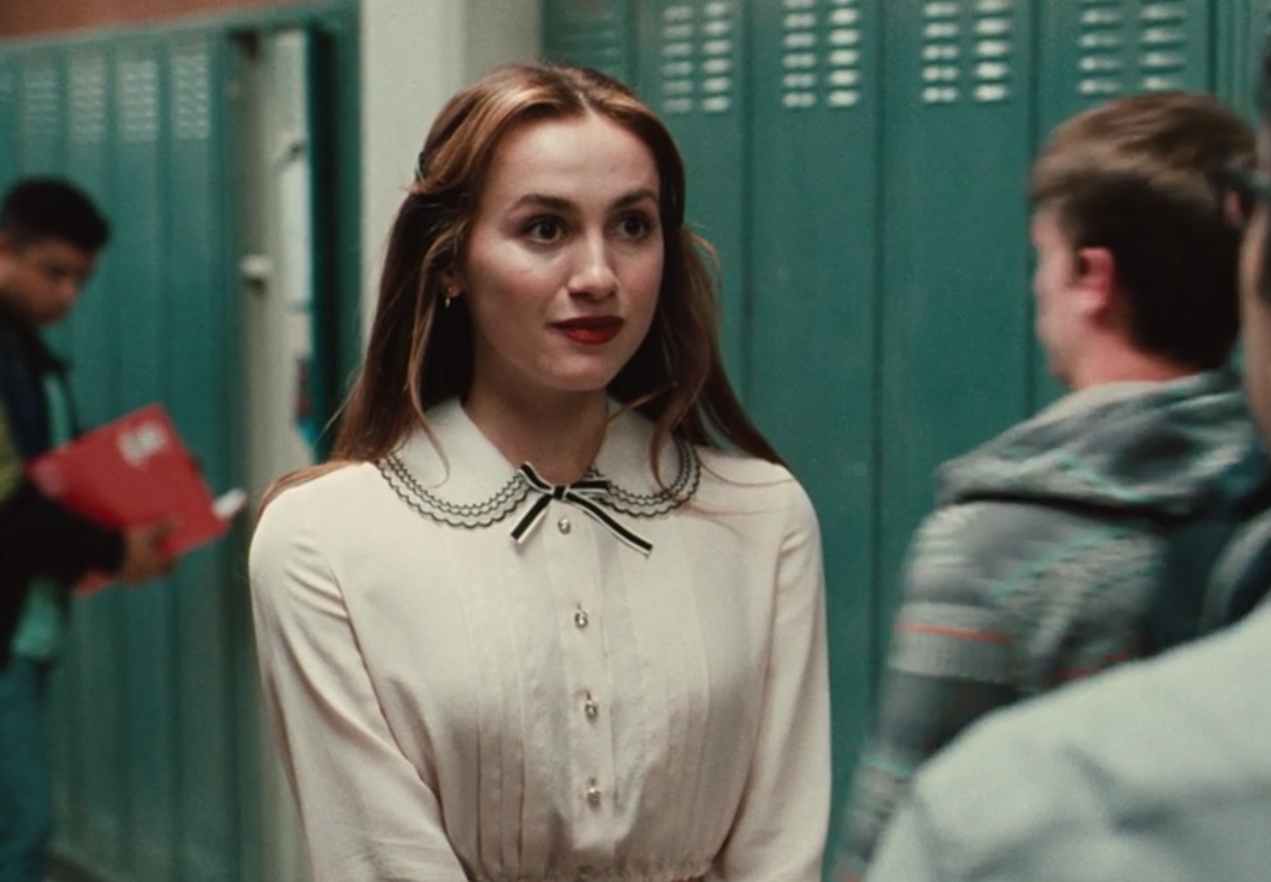 Lexi wears a buttoned blouse with a Peter Pan collar and small bow in &quot;Euphoria&quot;