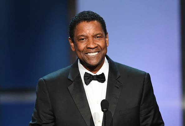 Denzel is delivering a speech while dressed in formal attire