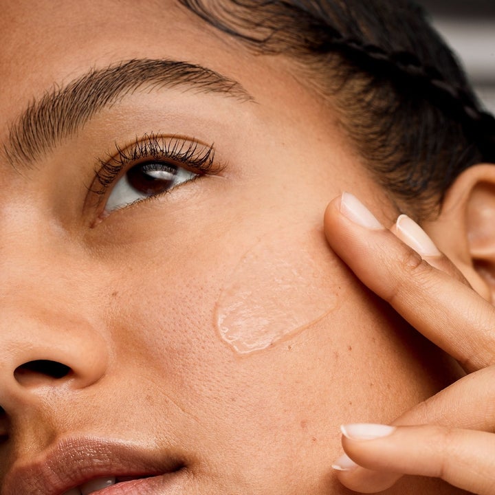 model applying the primer to their face