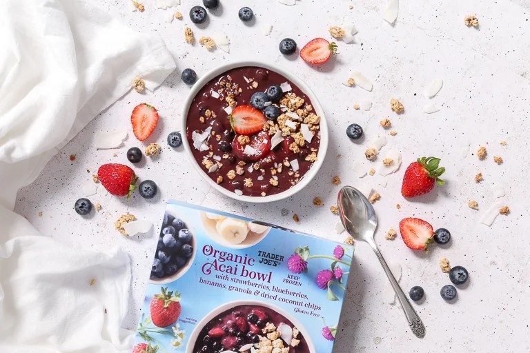 Ready made Organic Açai Bowl surrounded by berries, next to the open box
