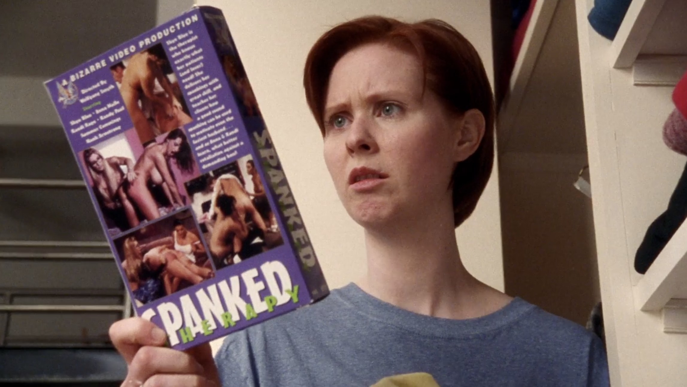 Miranda looking at a porn tape called Spanked on Sex and the City