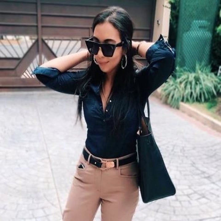 Reviewer wearing the square black cat eye sunglasses