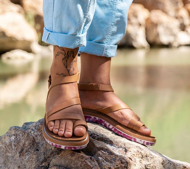 model wearing the tan colored sandals