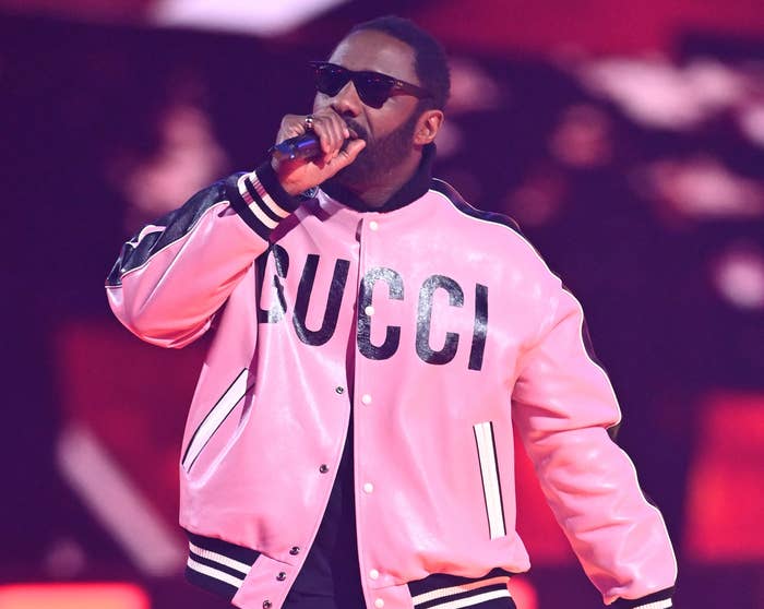 Idris wears a pink Gucci bomber jacket while on stage