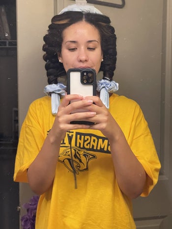 a reviewer with their hair wrapped in the curler before bed