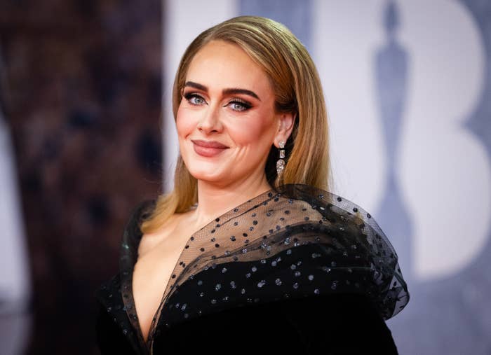 Adele slightly smiling on the red carpet of the Brit Awards