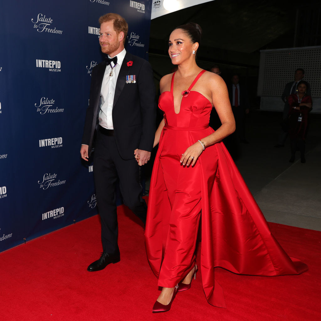 Meghan is in a gorgeous red gown with Prince Harry