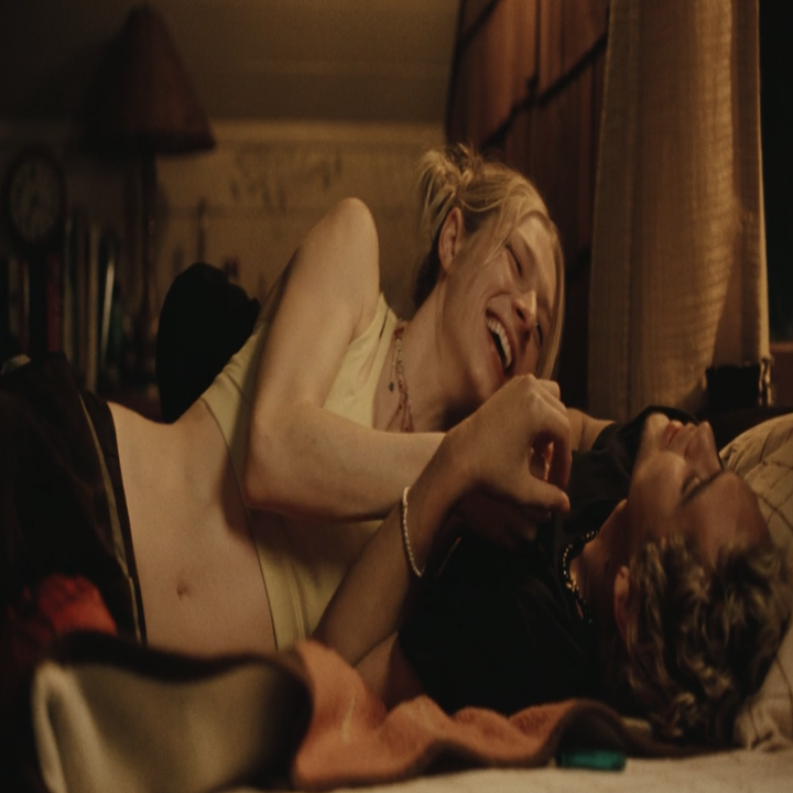 Hunter and Dominic lying on a bed and laughing in a scene from Euphoria