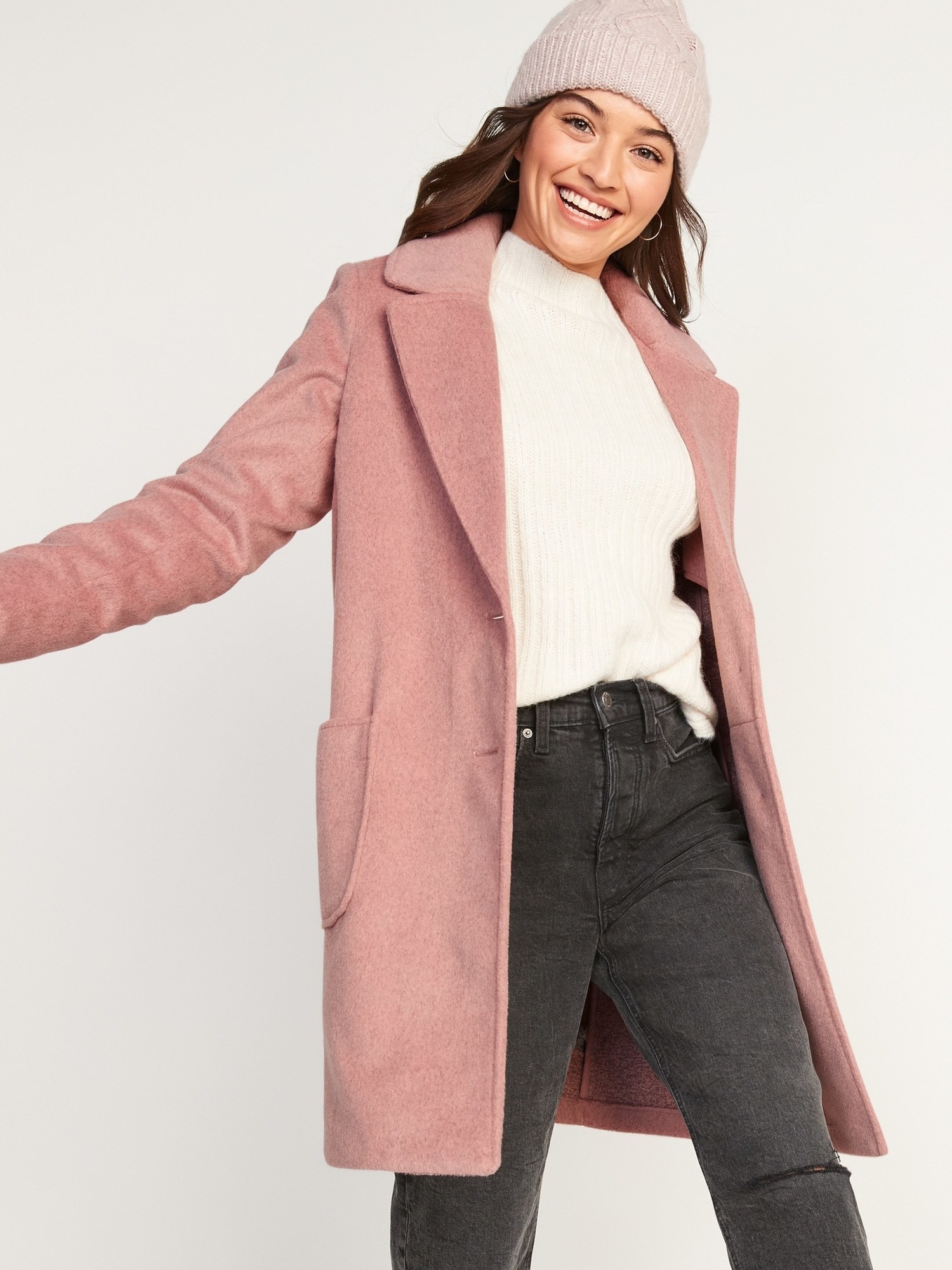 Model posing in pink coat