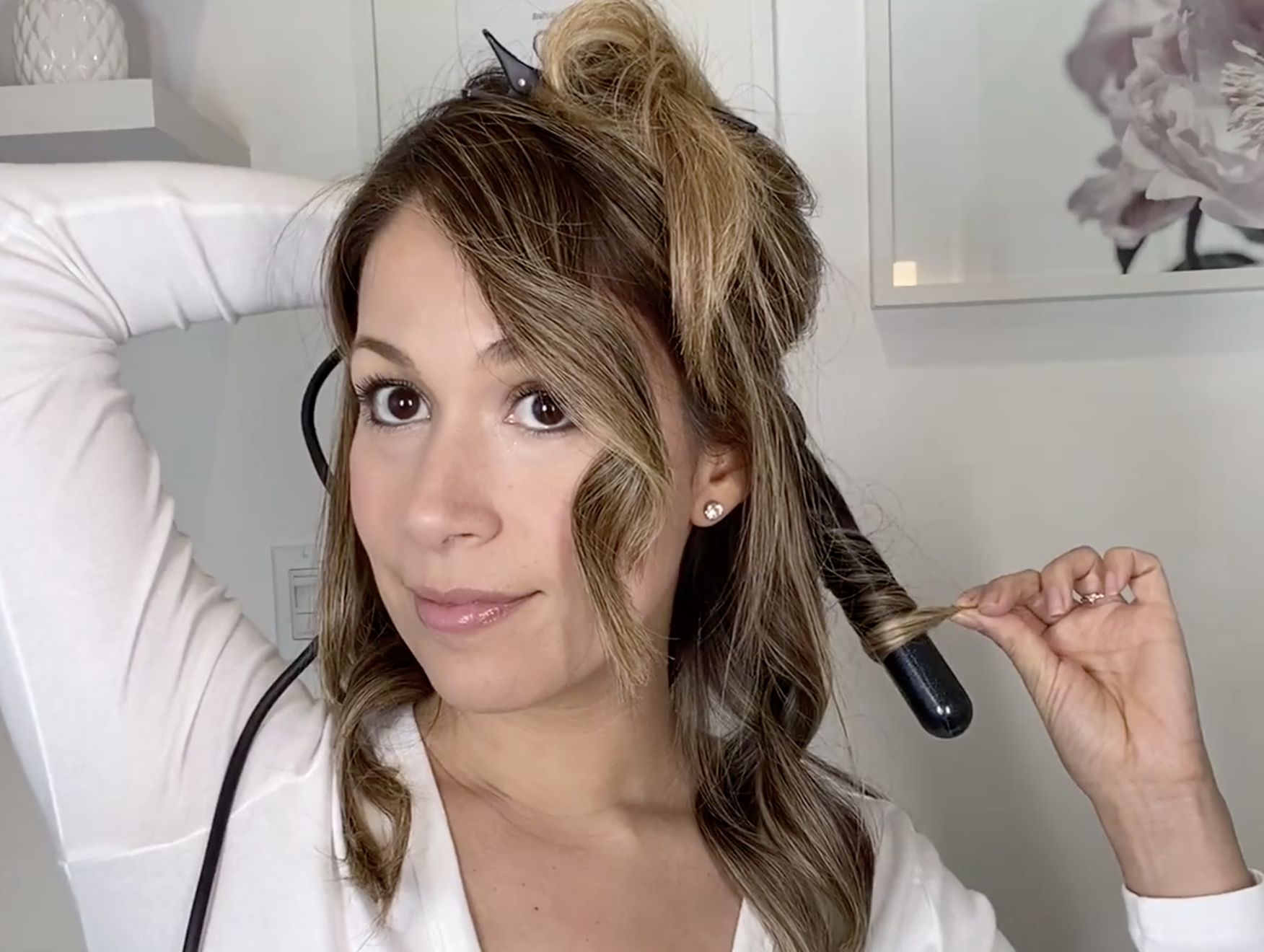 Model is curling their hair with the wand