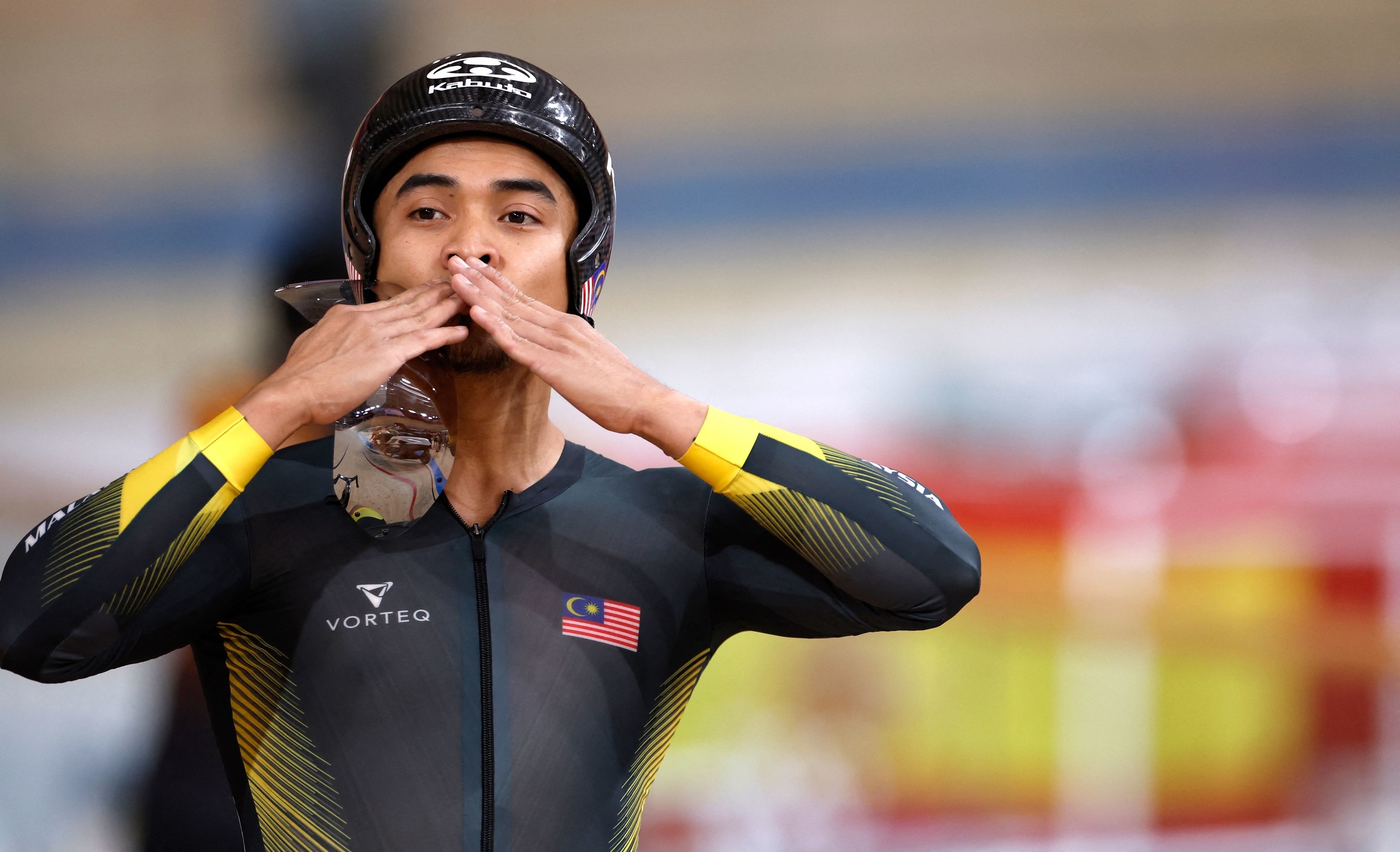 An Malaysian athlete blowing a kiss to the crowd