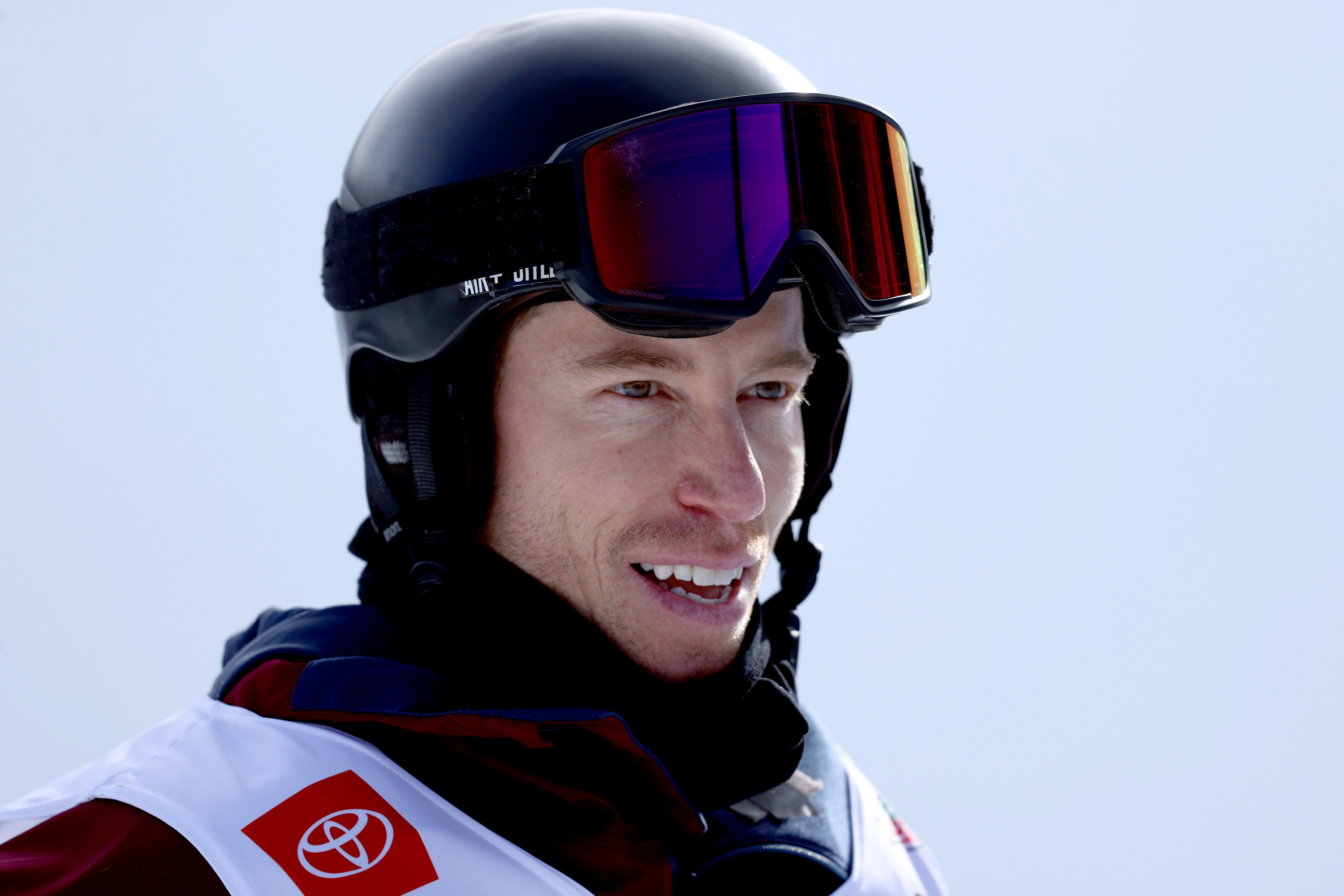 A closeup of Shaun White wearing his helmet and the rest of his gear at the Olympics