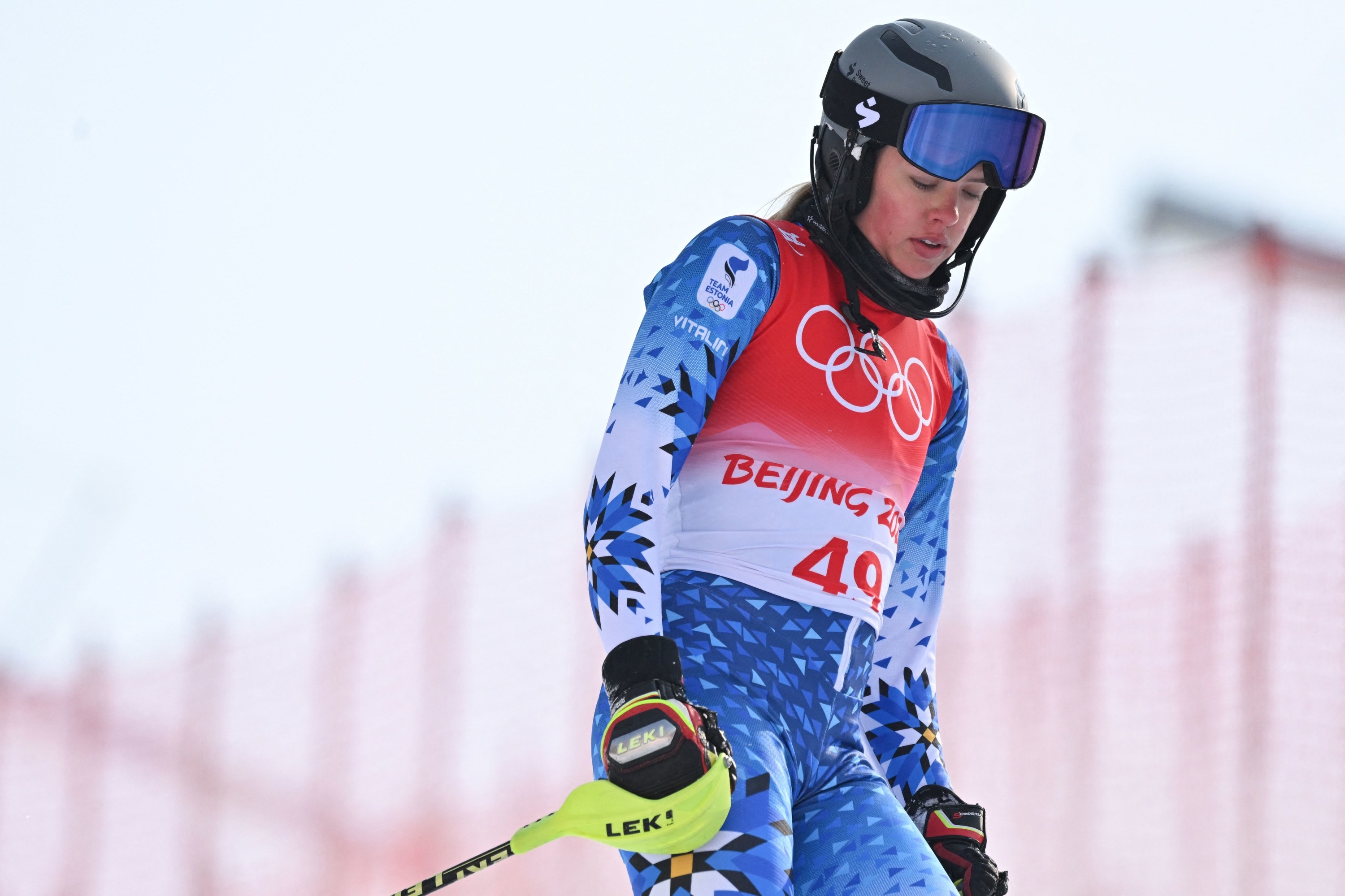 A closeup of an Estonian athlete standing on the slope