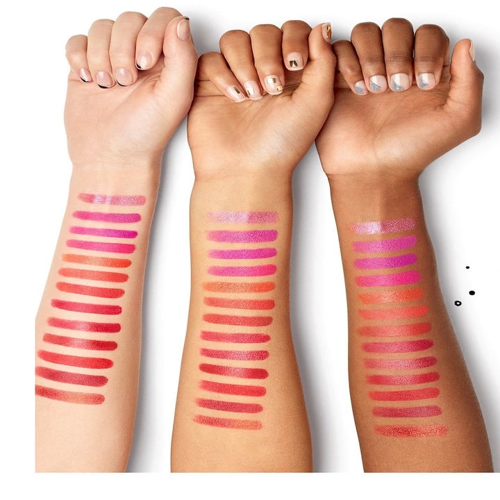 three models' arms with swatches of the different lipstick colors