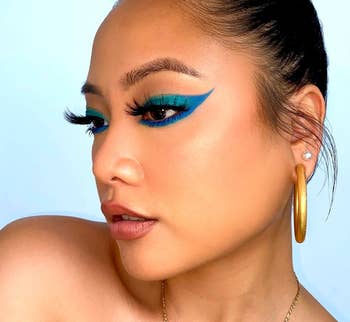 model wearing blue and green eye makeup