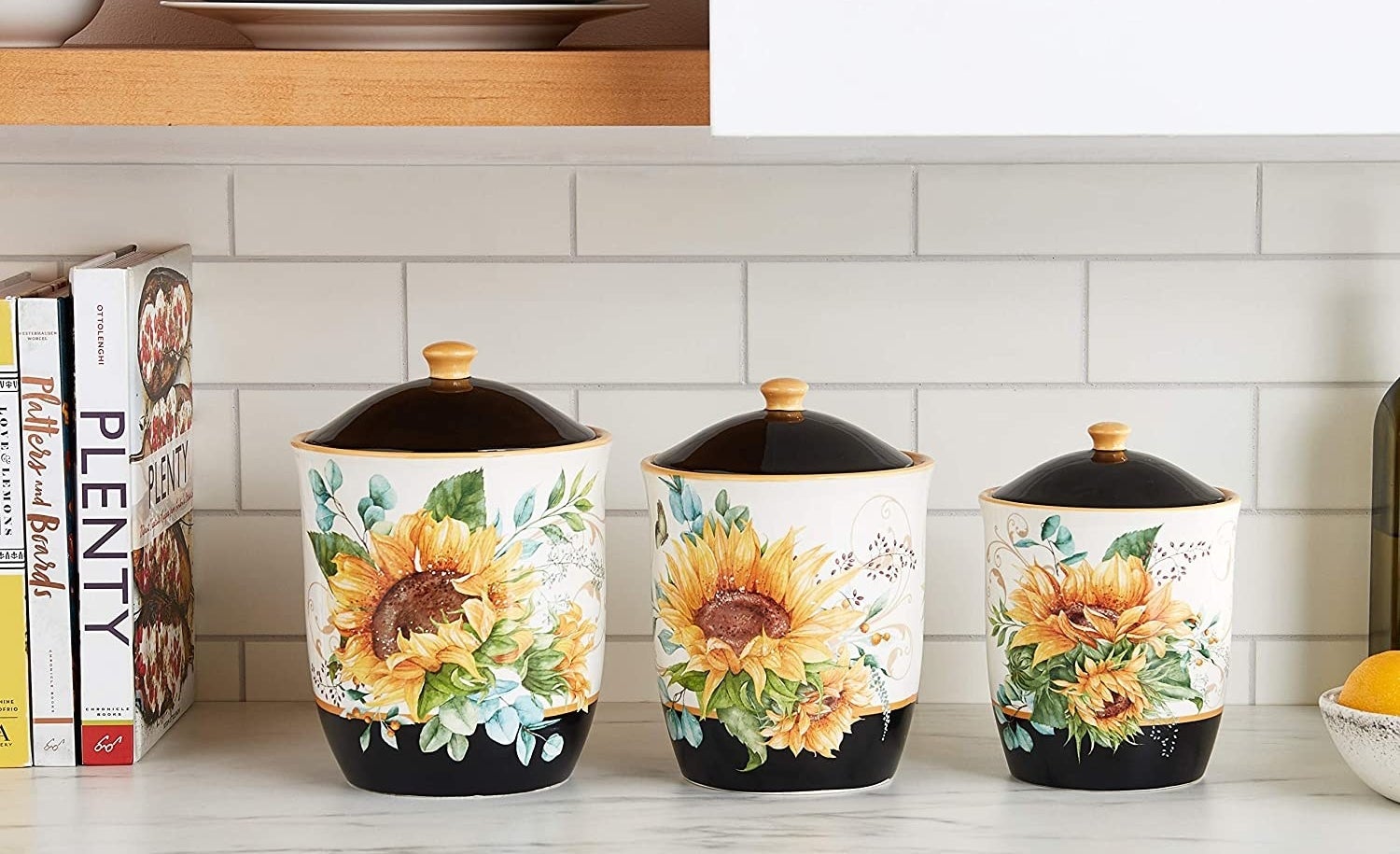three piece sunflower canister set on a countertop